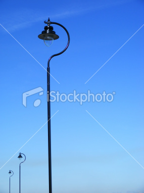 ist2_7548715-three-black-lamposts-against-blue-sky