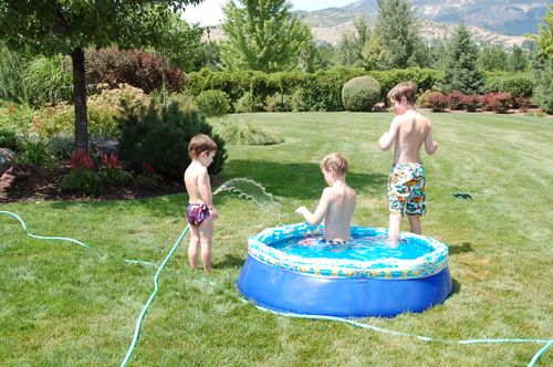 Funky white boys playing in the hose.