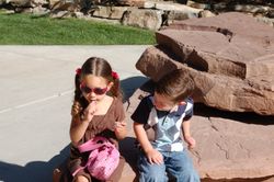 Supermodel Jr. putting on lipstick. Toddler Child watching.